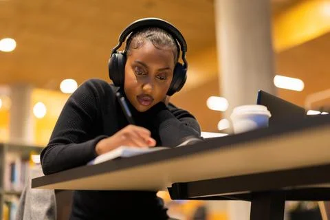 Student studying in modern library Stock Photos
