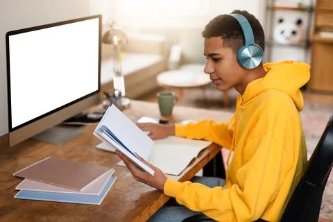 Student studying with notebook and computer at desk Stock Photos
