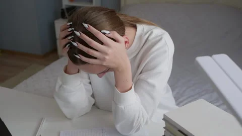 Student suffering from headache while studying at home Video stock 315174864