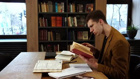 Student at the table with books Stock Footage 155963034