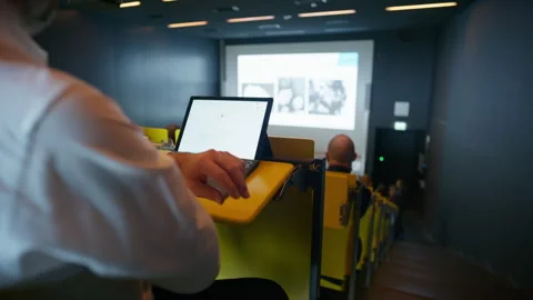 Student Takes Digital Notes on Laptop During University Lecture Session Video stock 331399749