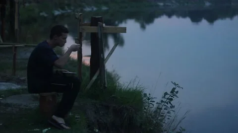 Student is taking meal on the river Stockbeeldmateriaal 53569048