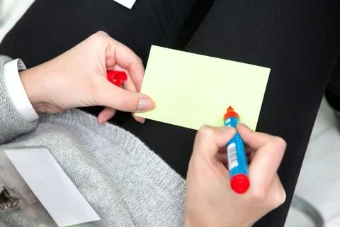 Student taking notes in classroom. business education concept, casual young b Stock Photos