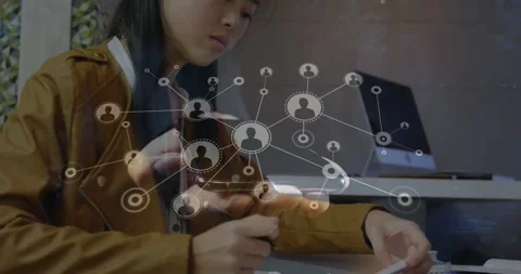 Student taking notes at desk, network graphic appearing over phone guiding paper Stock Footage 331109411