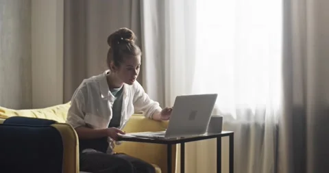 Student taking notes during remote lesson via laptop Stock Footage 172142575