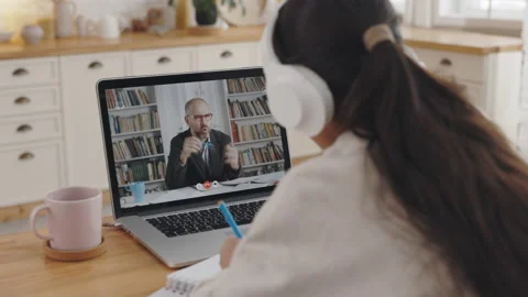 Student taking notes during video lesson with teacher Video stock 155164713