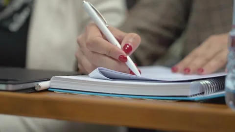 A student is taking notes in a lecture at the university Stock Footage 303346798