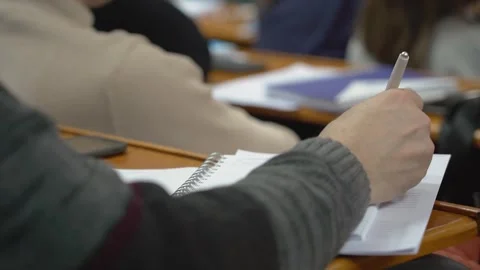 A student is taking notes in a lecture at the university Stock Footage 303346802
