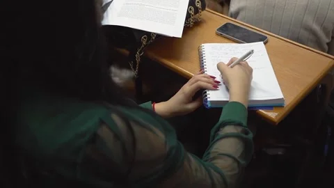 A student is taking notes in a lecture at the university Stock Footage 303346810