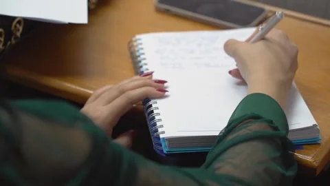 A student is taking notes in a lecture at the university Stock Footage 303346811
