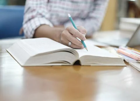 Student Taking Notes in Library with Laptop Stock Photos