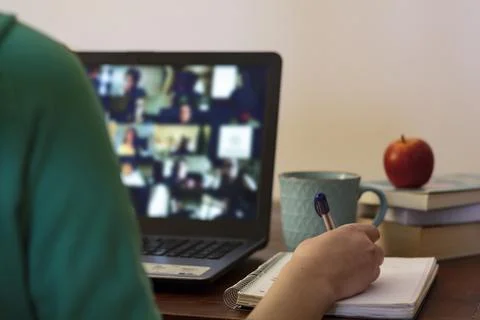 Student taking notes at online class Stock Photos