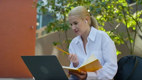Student taking online class and making notes Stock Footage 317437129