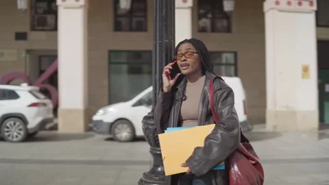 Student talking on phone in city square. Stock Footage 307019144