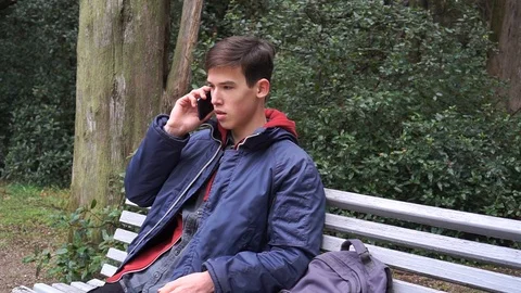 Student talking on phone in the park Stock Footage 102782064