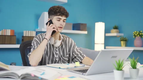 The student talking on the phone while studying at home is angry. Stock Footage 237035584