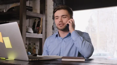 Student talking on the phone while working Stock Footage 104138464