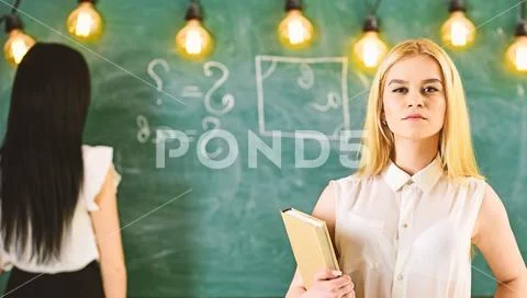 Student, teacher in formal wear stand in classroom. Students and trainees Stock Photos
