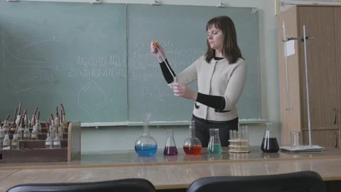Student, teacher mixing sample in flask with sample in tube Stock Footage 86257089