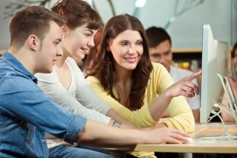 Student &amp; teacher using computers at college Stock Photos