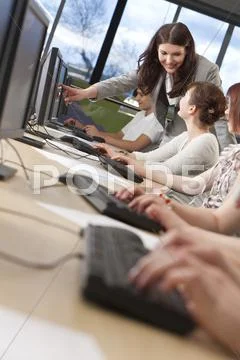 Student & teacher using computers at college Stock Photos