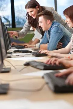 Student &amp; teacher using computers at college Stock Photos