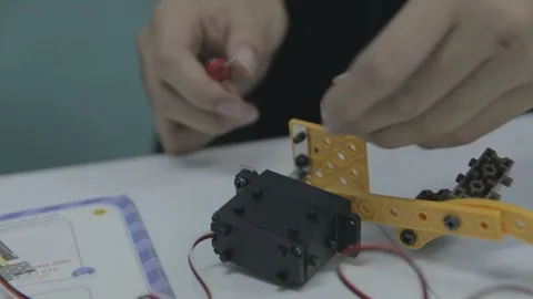 Student testing a home made remote control toy vehicle Stock Footage 87723915