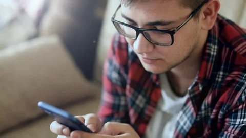 Student texting a message on mobile phone Stock Footage 86348633