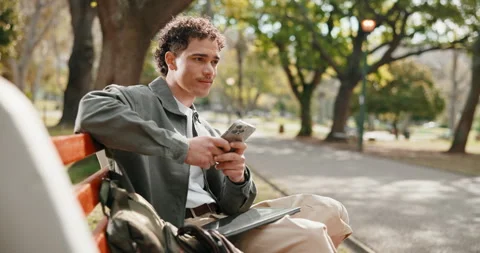 Student, thinking and happy man with phone, outdoor and exam update on web and Stock Footage 346124539