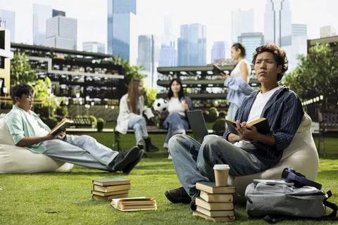 Student thinking and pauses reading page from open book Stock Photos