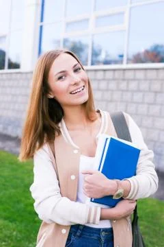 Student tilting her head to the side and smiling Stock Photos