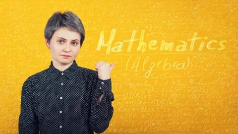 Student tired of learning, pointing finger to a yellow wall with written math Stock Photos