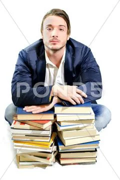 Student tired of studying on piles of books Stock Photos