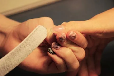 A student at the training courses of a manicure prepares the hand of a lady c Photos