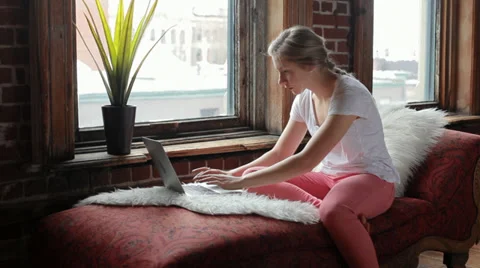 Student Types On Her Laptop And Looks Out Window Stock Footage 36114366