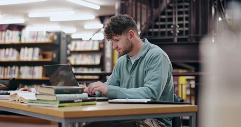 Student, typing and man in library, laptop and problem solving with education Stock Footage 286372721