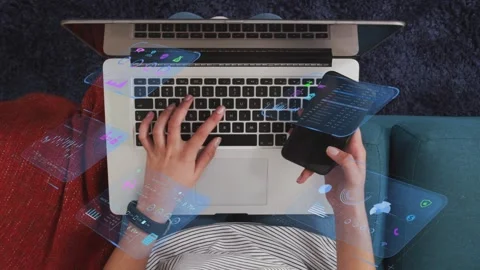 Student typing and tilting phone, activating 3D overlays over laptop keyboard Stock Footage 334351890