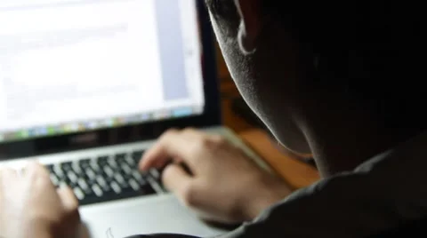 Student Typing in a computer at night Stock Footage
