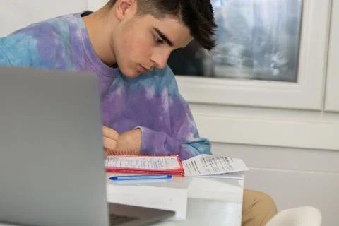 Student typing at desk with personal computer or laptop Stock Photos