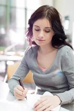 Student in a university library taking notes Stock Photos