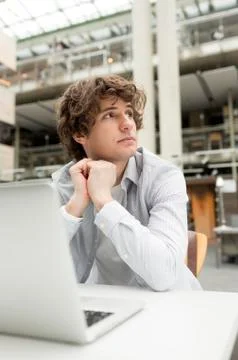 Student in a university library using laptop Stock Photos