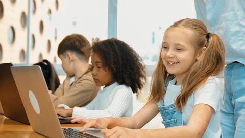 Student use laptop writing code while teacher explain about program. Erudition. Foto stock