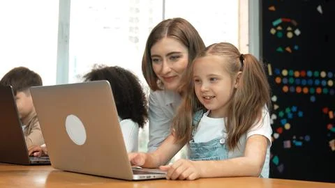 Student use laptop writing code while teacher explain about program. Erudition. Photos