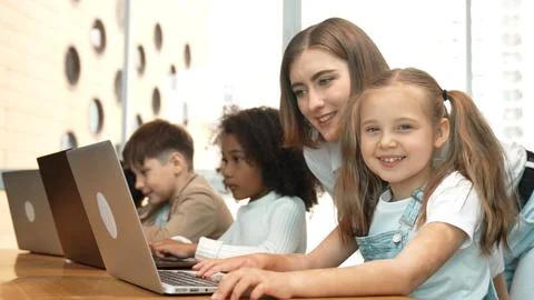 Student use laptop writing code while teacher explain about program. Erudition. Foto stock