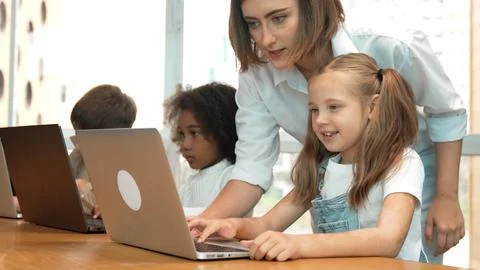 Student use laptop writing code while teacher explain about program. Erudition. Photos