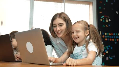 Student use laptop writing code while teacher explain about program. Erudition. Foto stock