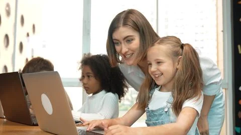 Student use laptop writing code while teacher explain about program. Erudition. Foto stock