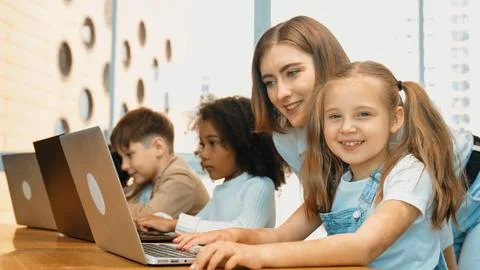 Student use laptop writing code while teacher explain about program. Erudition. Foto stock