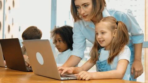 Student use laptop writing code while teacher explain about program. Erudition. Photos