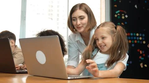 Student use laptop writing code while teacher explain about program. Erudition. Foto stock